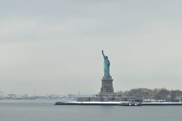 The Statue of Liberty surrounded by gray skies.